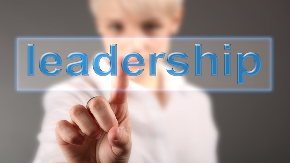 A woman pointing to the word leadership
