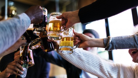 A picture taken in a pub of multiple people with pints