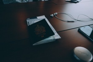 Someone with a passport on their desk