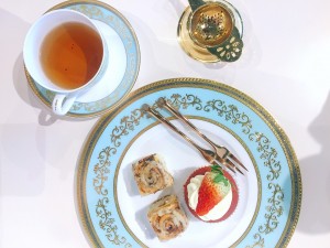 An afternoon tea with cake and tea strainer