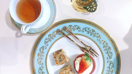 An afternoon tea with cake and tea strainer