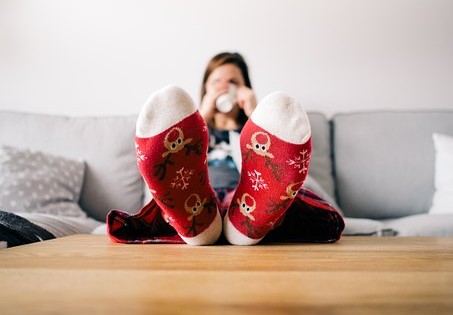 Lady wit her feet up, enjoying the fact she can be lazy