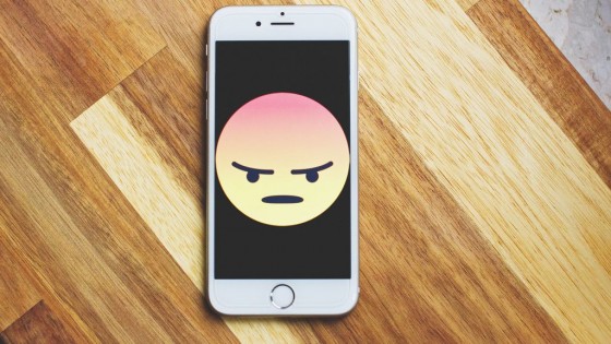 Phone with an angry emoji on