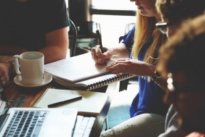 Image of young business types in a meeting around a tabel