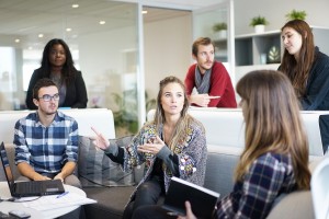 A group of people looking interested in each other for the metaphor of being human in the work place