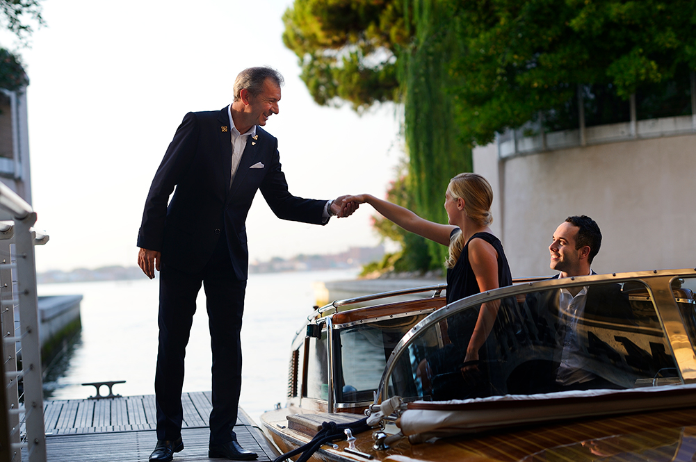 Guests being welcomes via boat to the hotel