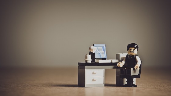 Lego man at a lego desk looking stressed