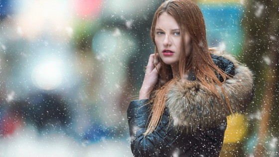 Woman in snow facing camera looking annoyed