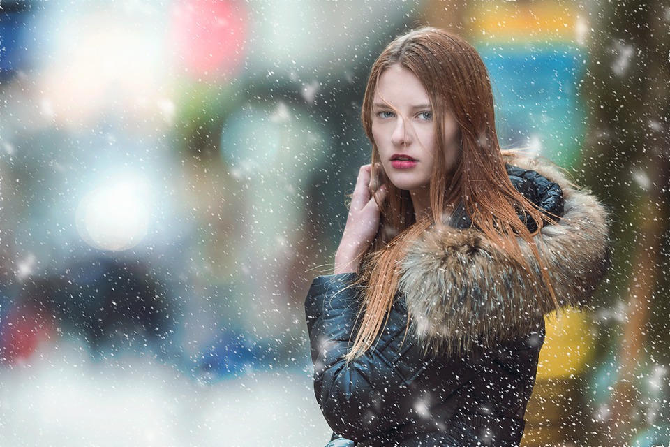 Woman in snow facing camera looking annoyed
