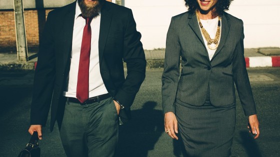 Man and woman in suit walking towards the camera in a business like fashion