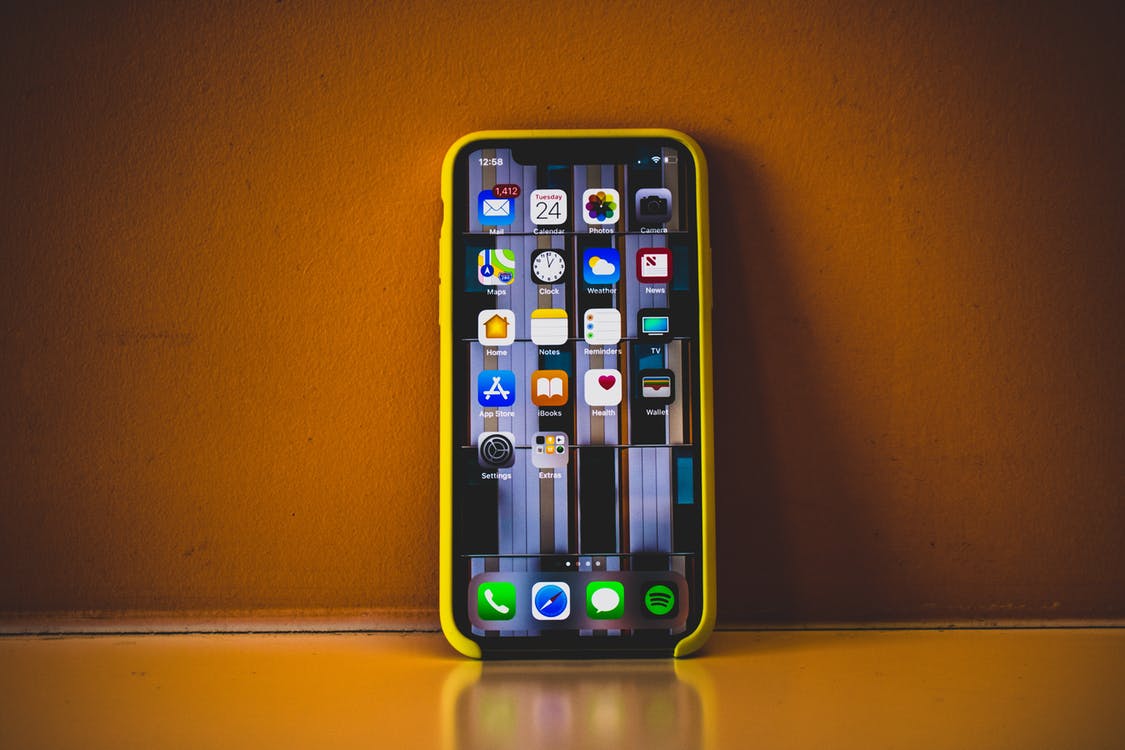 Iphone XR with apps - phone is yellow and orange sunburnt background