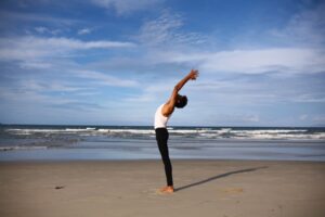 wellbeing-support-at-workplace-yoga-on-the-beach