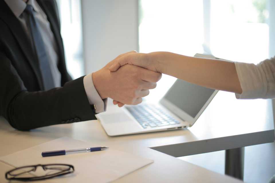 attracting-talented-Personal-Assistants-shaking-hands-in-an-office