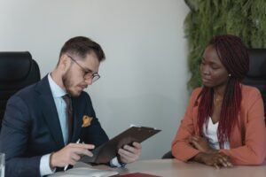 Two colleagues seated across a desk during a professional development meeting, discussing performance and career goal