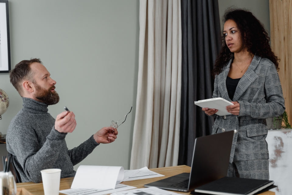 two colleagues talking in an office