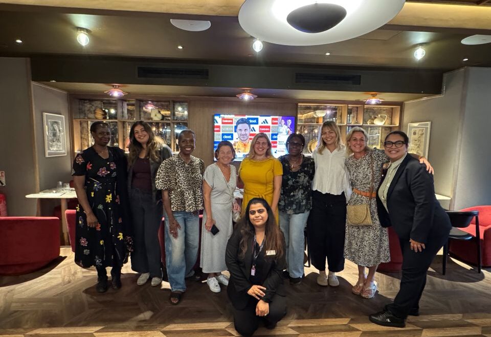 people posing in a group setting in a hotel