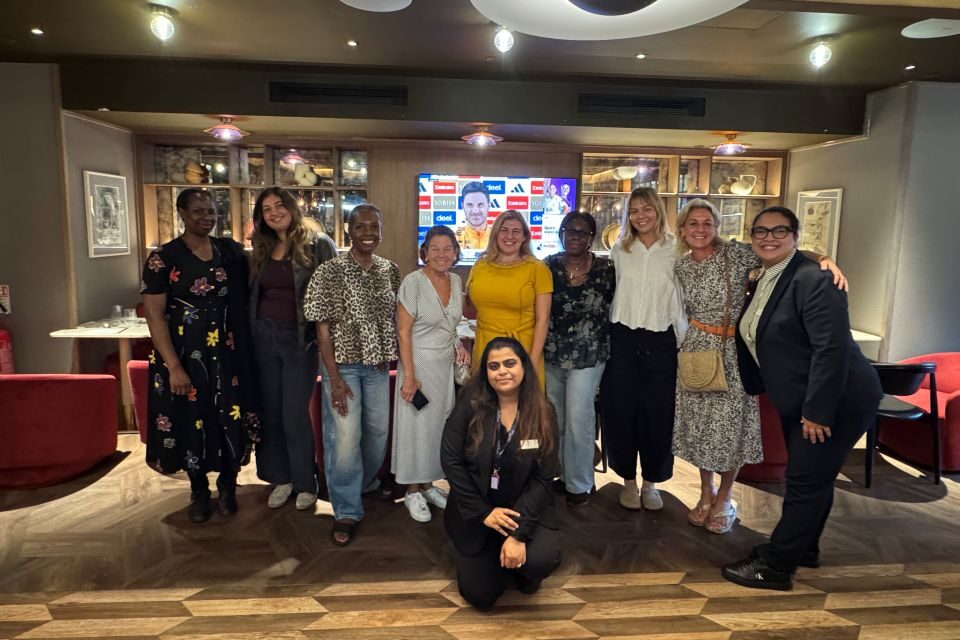 people posing in a group setting in a hotel